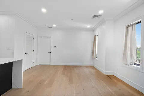 a view of room with window and hardwood floor