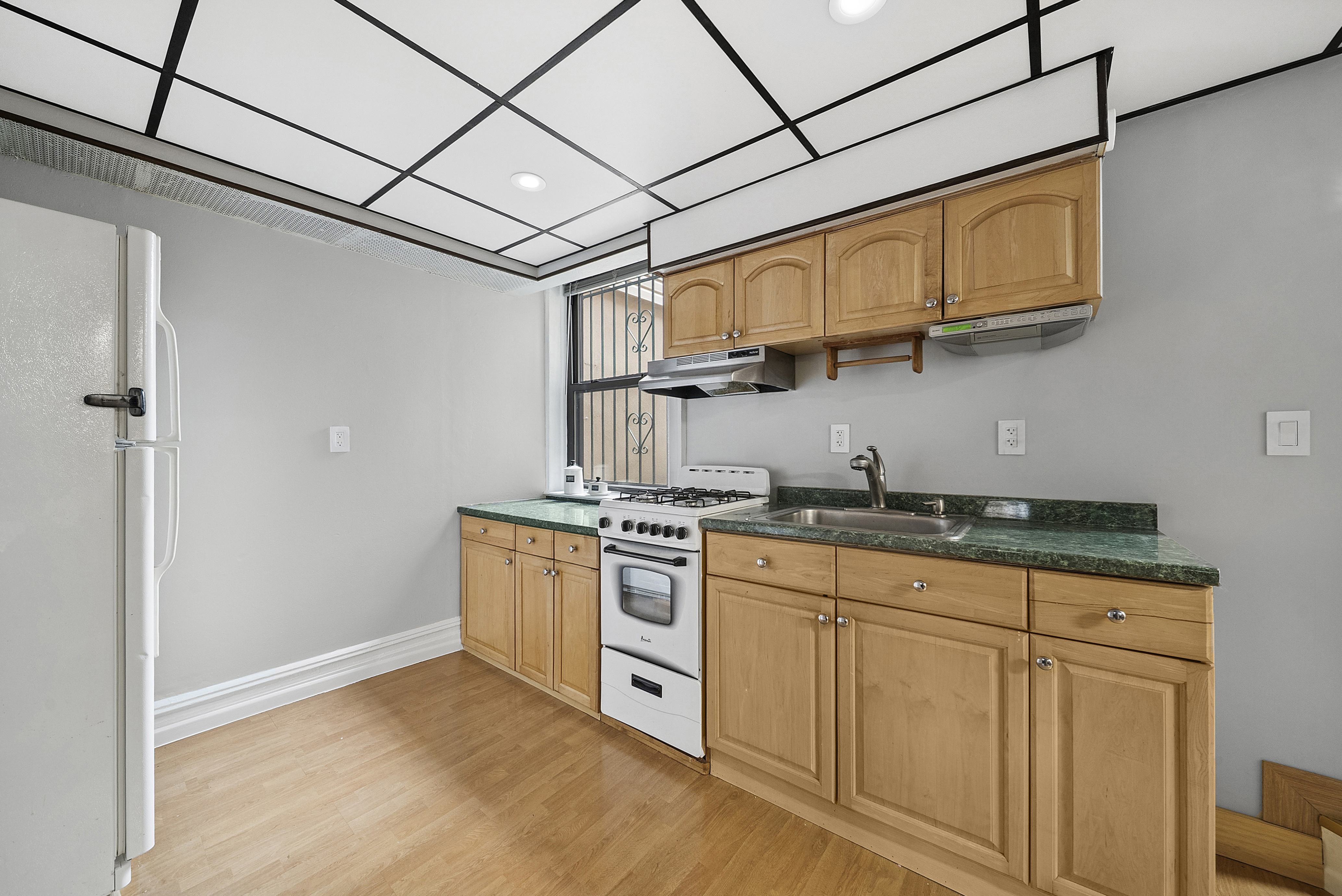 203 Battery Avenue Brooklyn, NY 11209 - Photo 8 of 14 a kitchen with stainless steel appliances granite countertop a stove sink and cabinets