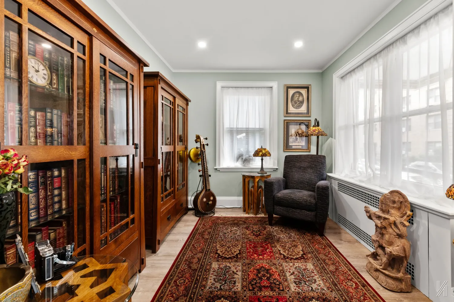 a living room with furniture a large window and a rug