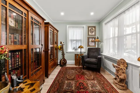 a living room with furniture a large window and a rug