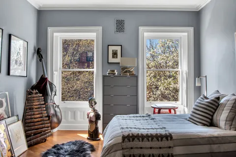 a bedroom with a bed and a window