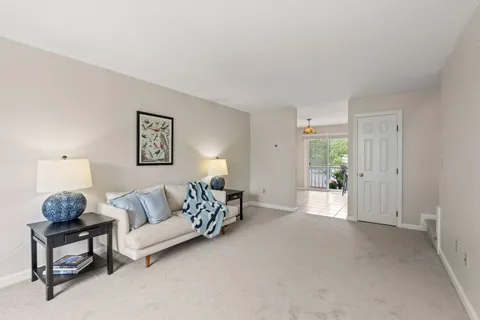 a living room with furniture and a lamp