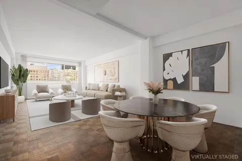 a living room with couches and painting on the wall