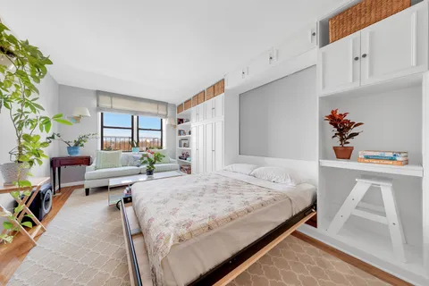 a bedroom with a bed and windows