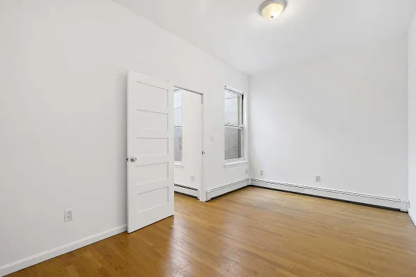 an empty room with wooden floor