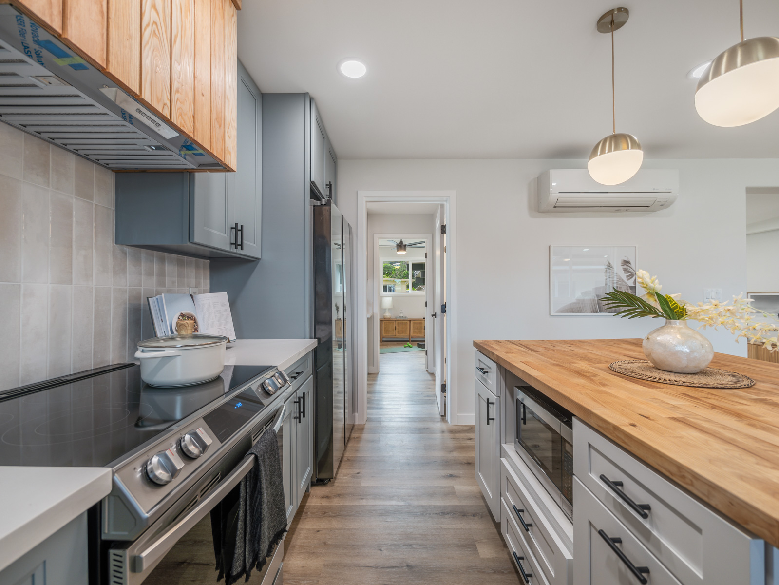 45-561 Paleka Road, Unit C Kaneohe, HI 96744 - Photo 4 of 27 a kitchen with stainless steel appliances granite countertop a stove a sink and a refrigerator