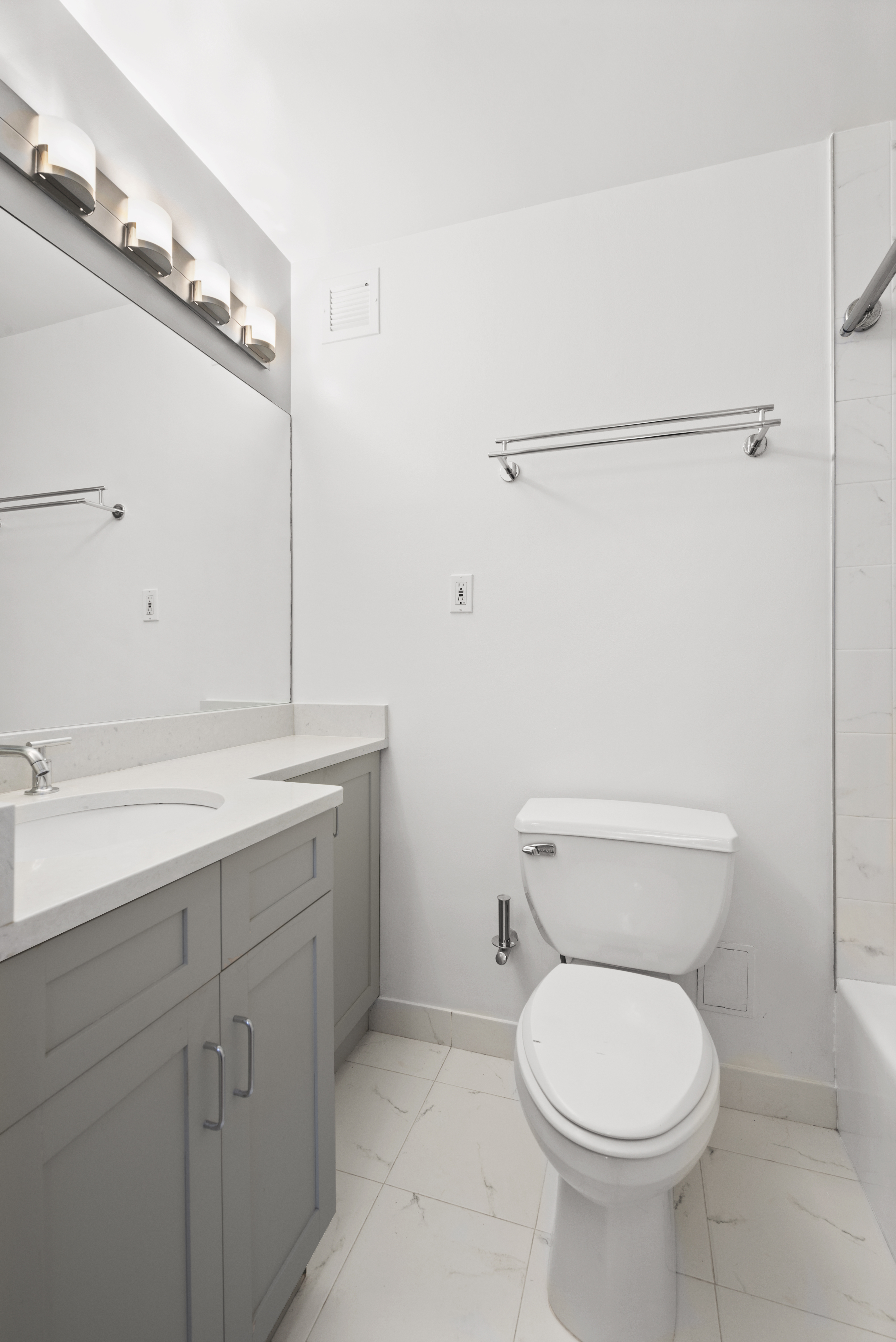 280 Rector Place, Unit 5O Manhattan, NY 10280 - Photo 5 of 7 a bathroom with a toilet sink and mirror