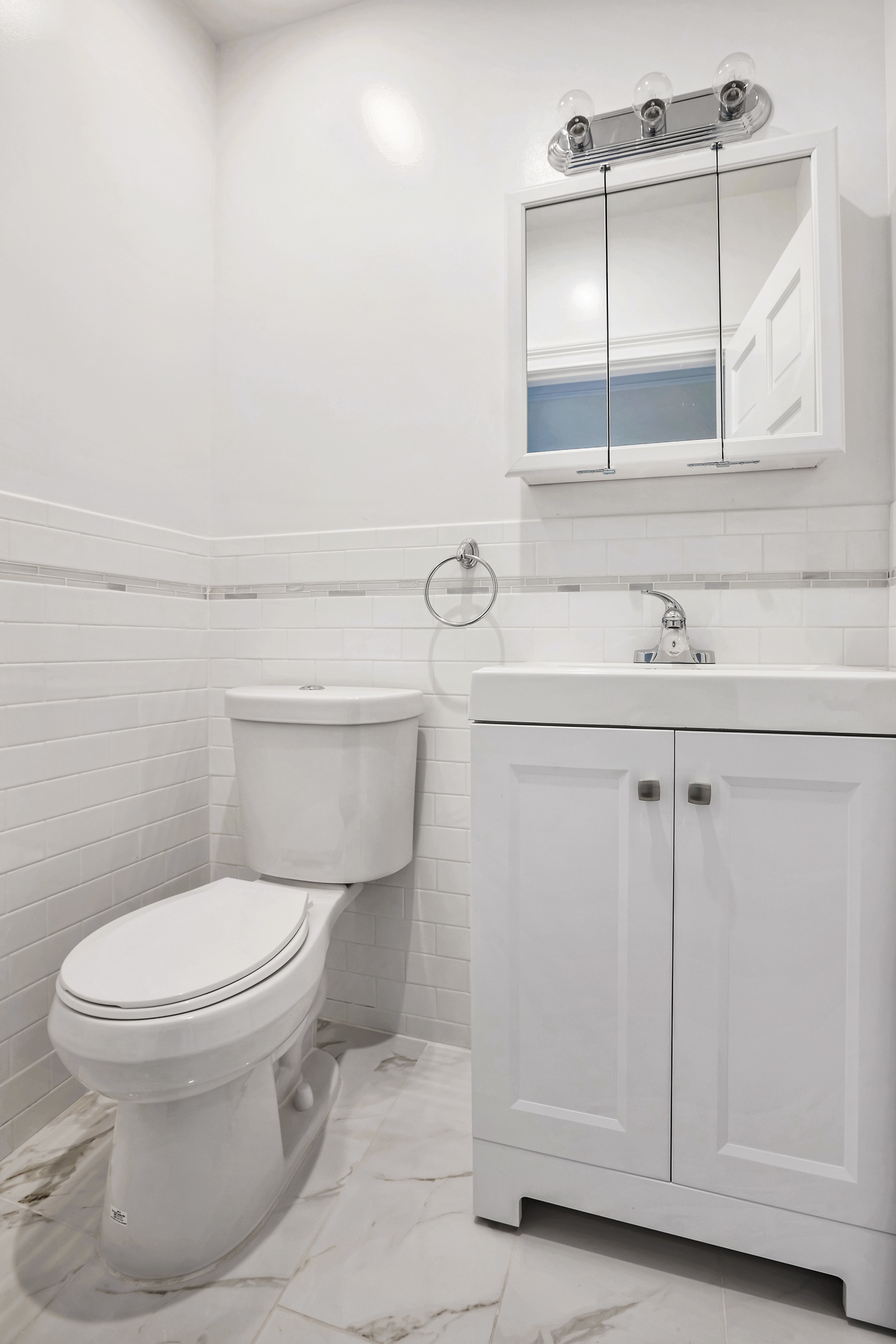 314 East 83rd Street, Unit 5W Manhattan, NY 10028 - Photo 4 of 4 a bathroom with a sink toilet and vanity