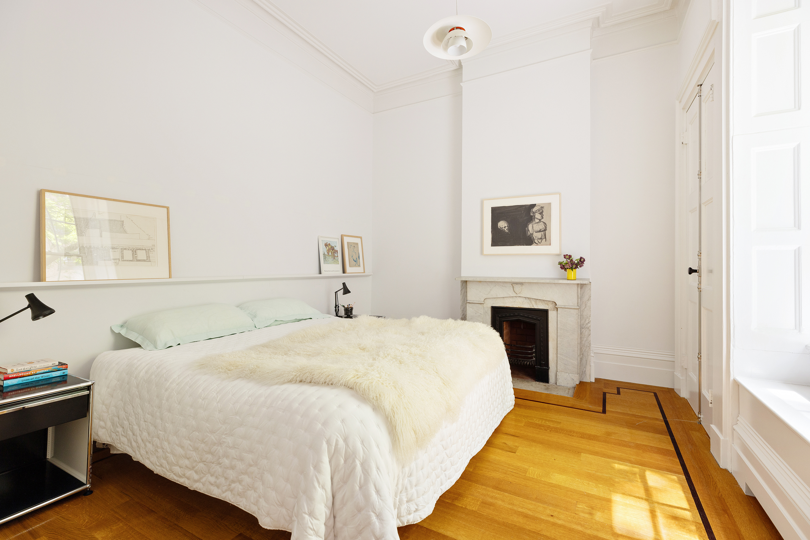 9 West 16th Street, Unit 3 Manhattan, NY 10011 - Photo 12 of 16 a bedroom with a bed and a fireplace