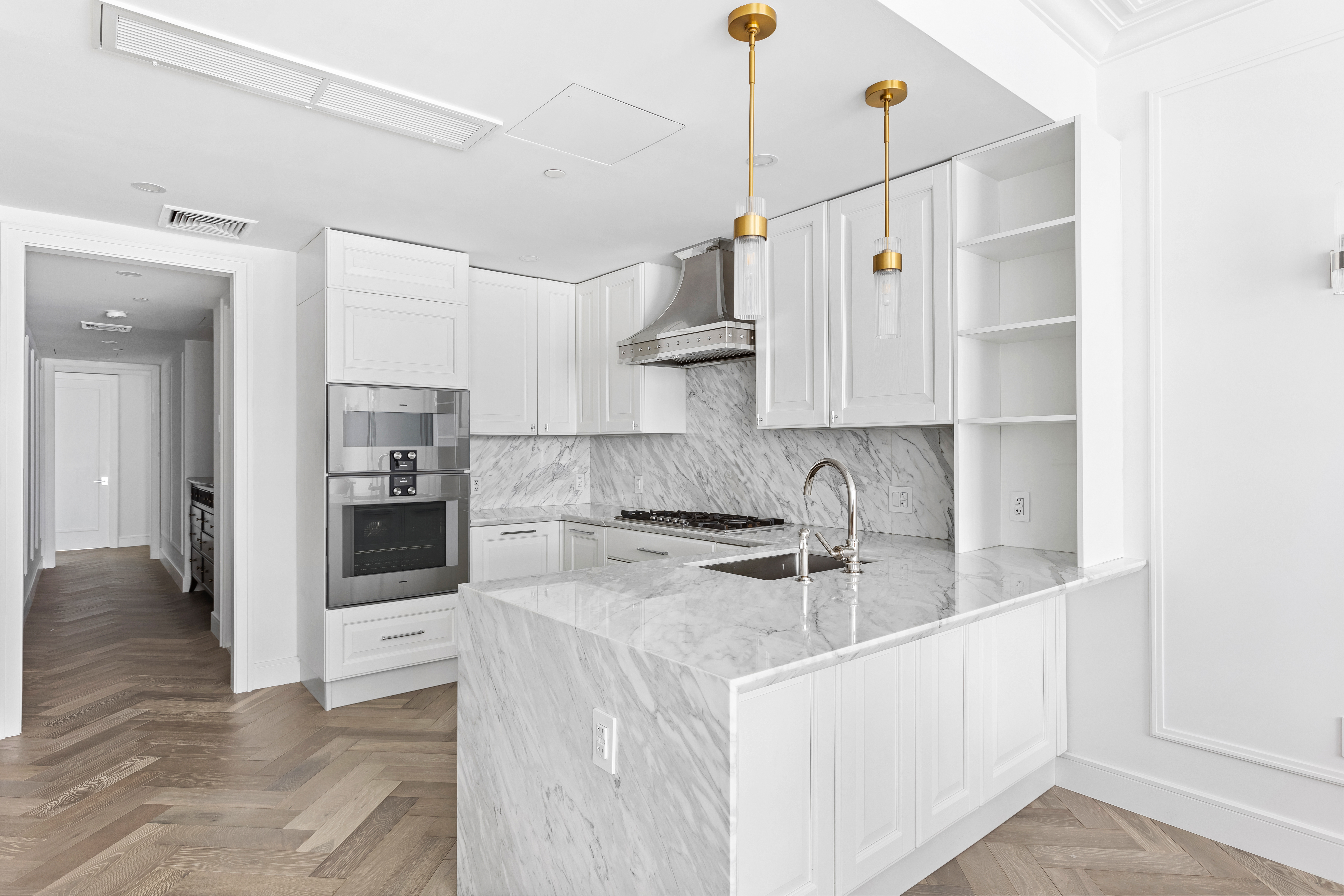 126 East 86th Street, Unit 5B Manhattan, NY 10028 - Photo 3 of 22 a kitchen with white cabinets and appliances