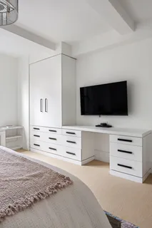 a view of a dresser with flat screen tv