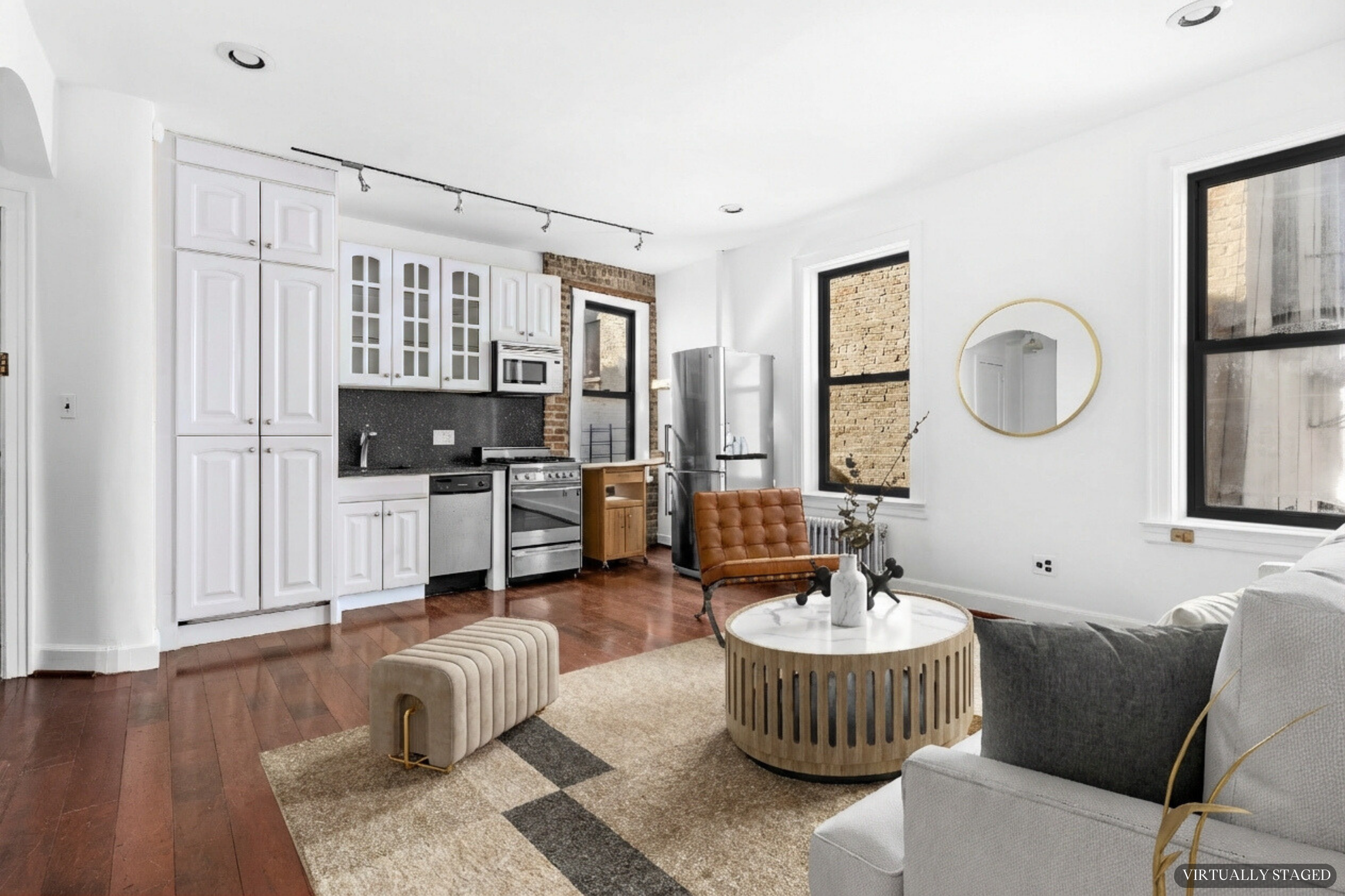 199 East 7th Street, Unit 4E Manhattan, NY 10009 - Photo 7 of 13 a living room with furniture a rug and kitchen view