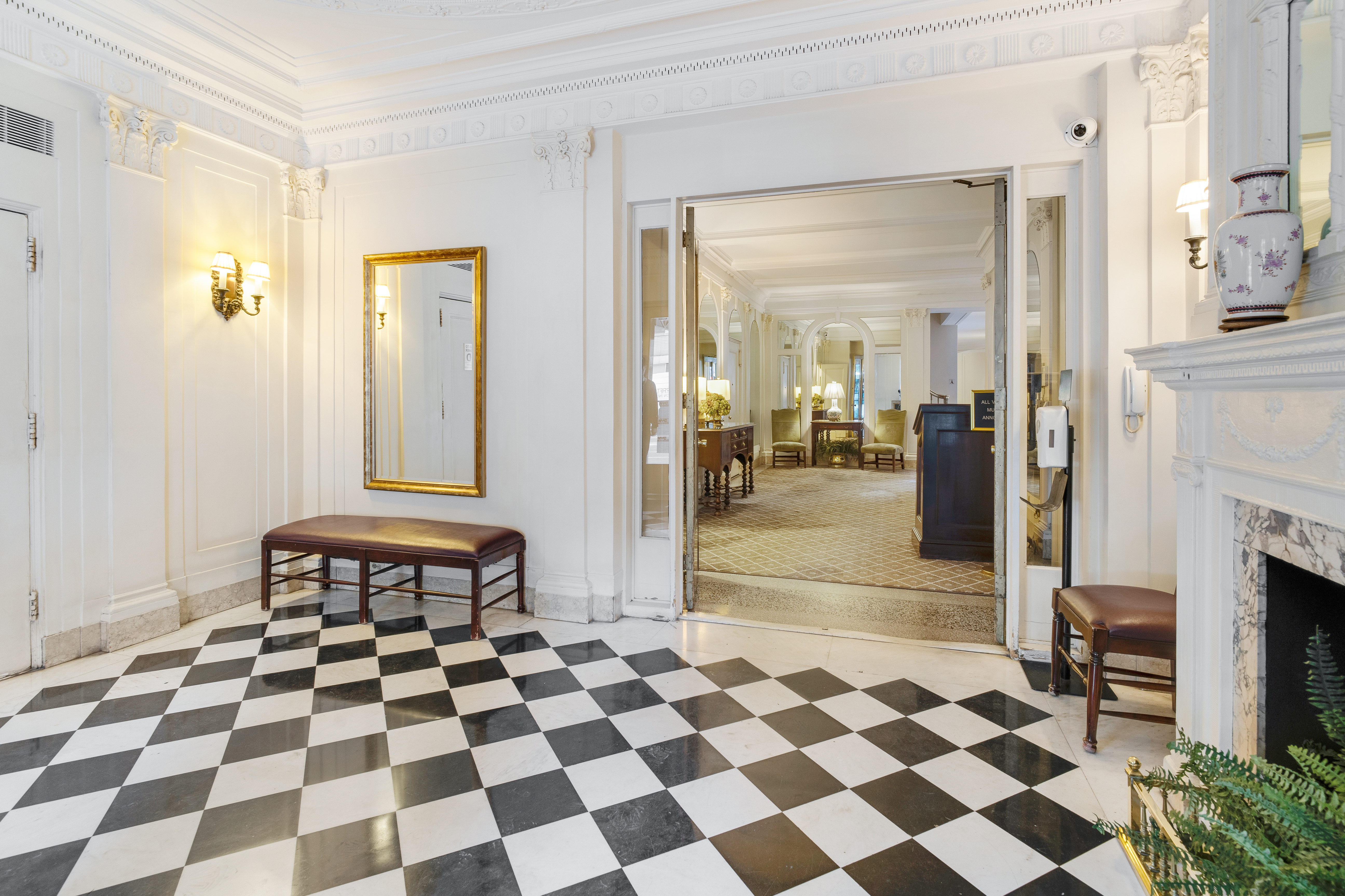 1349 Lexington Avenue, Unit PH2 Manhattan, NY 10128 - Photo 12 of 18 a living room with a black white checkered floor with a gaming machine and dining chair