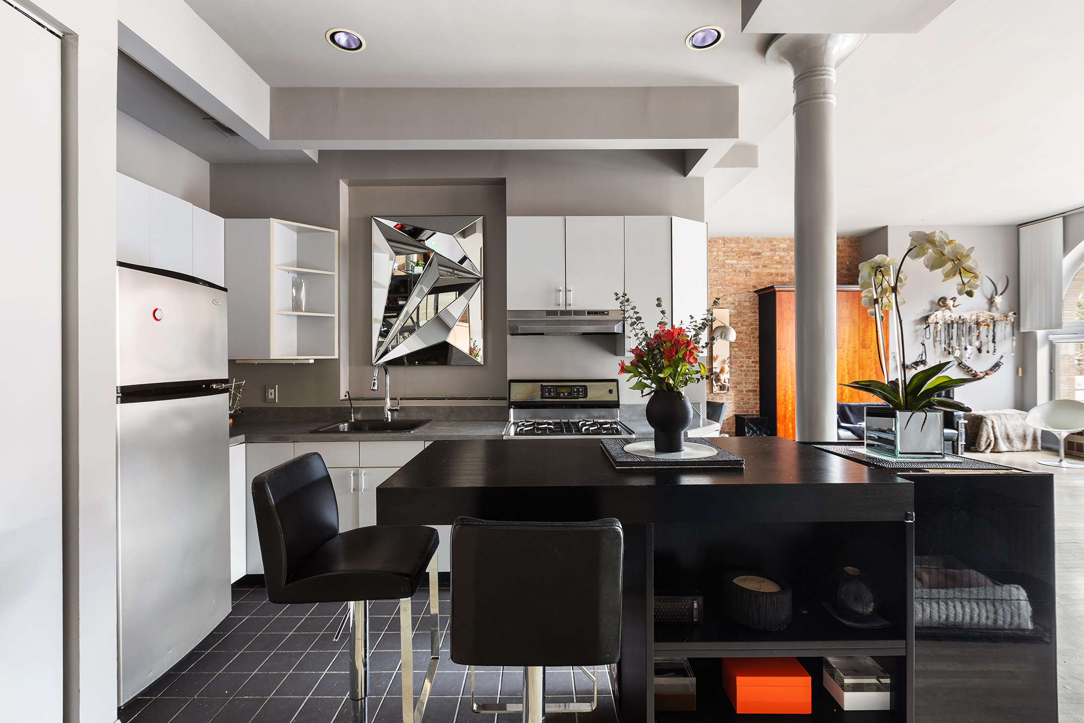 100 West 15th Street, Unit 4BC Manhattan, NY 10011 - Photo 4 of 9 a kitchen with a sink cabinets and window