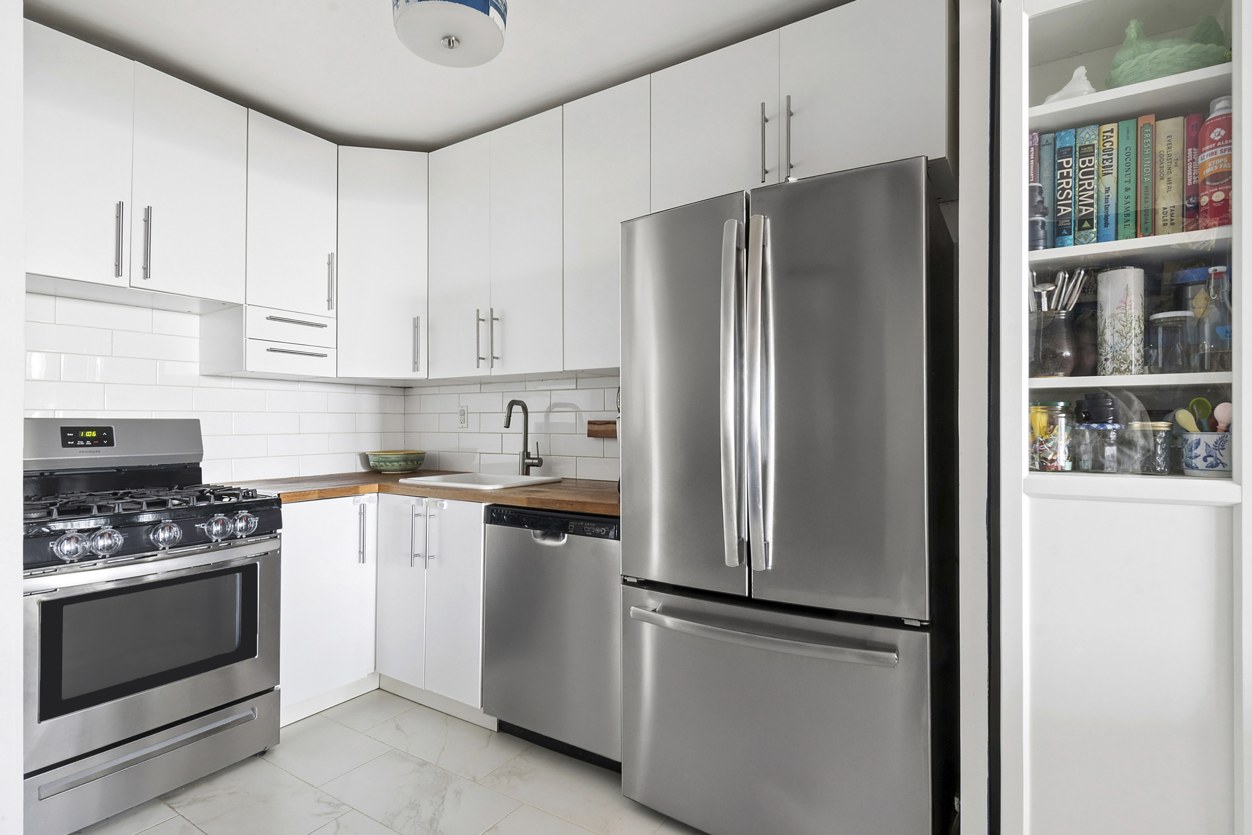 1655 Flatbush Avenue, Unit C1909 Brooklyn, NY 11210 - Photo 3 of 7 a kitchen with stainless steel appliances a refrigerator stove and cabinets