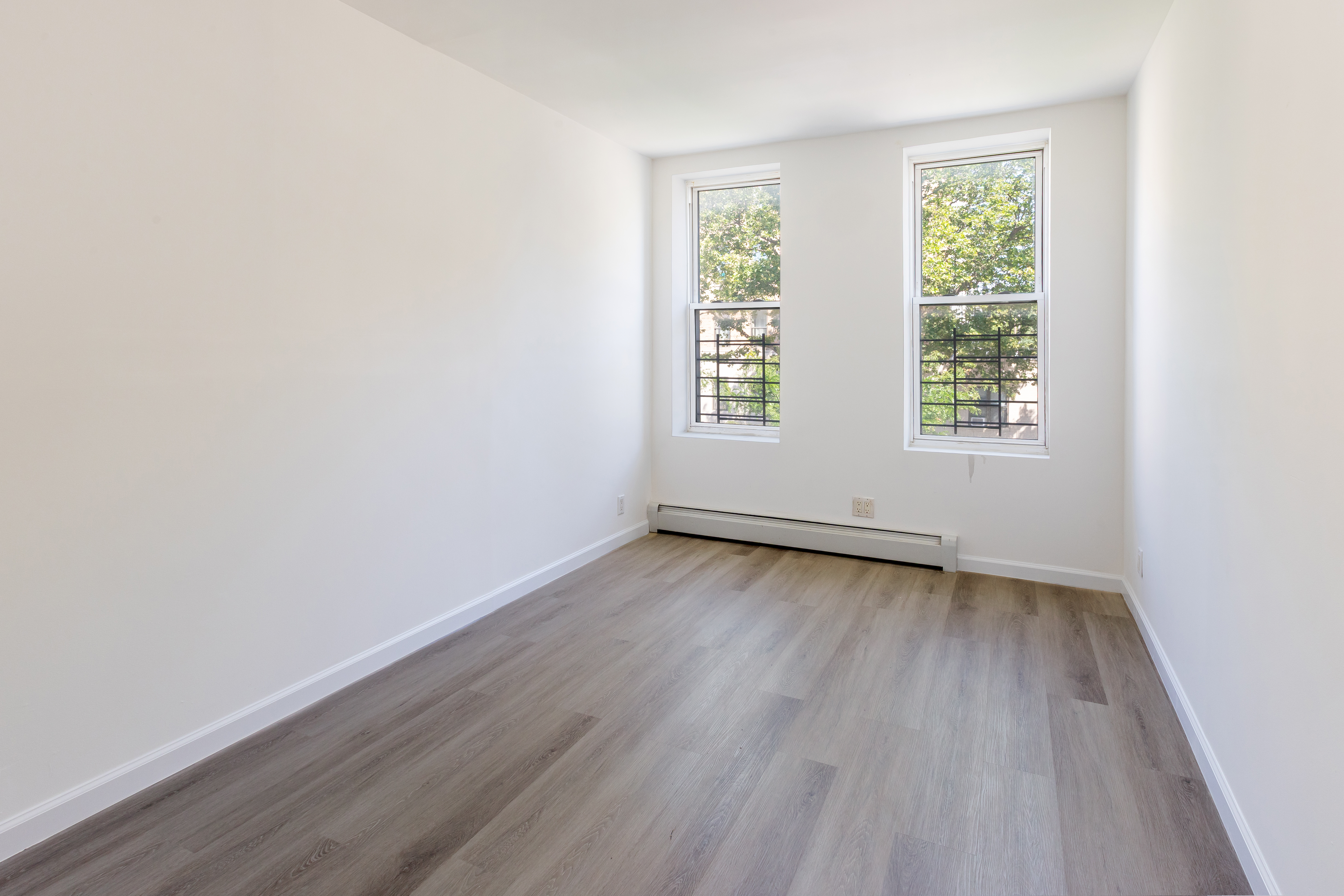 1030 Winthrop Street, Unit 2A Brooklyn, NY 11212 - Photo 5 of 10 an empty room with wooden floor and window