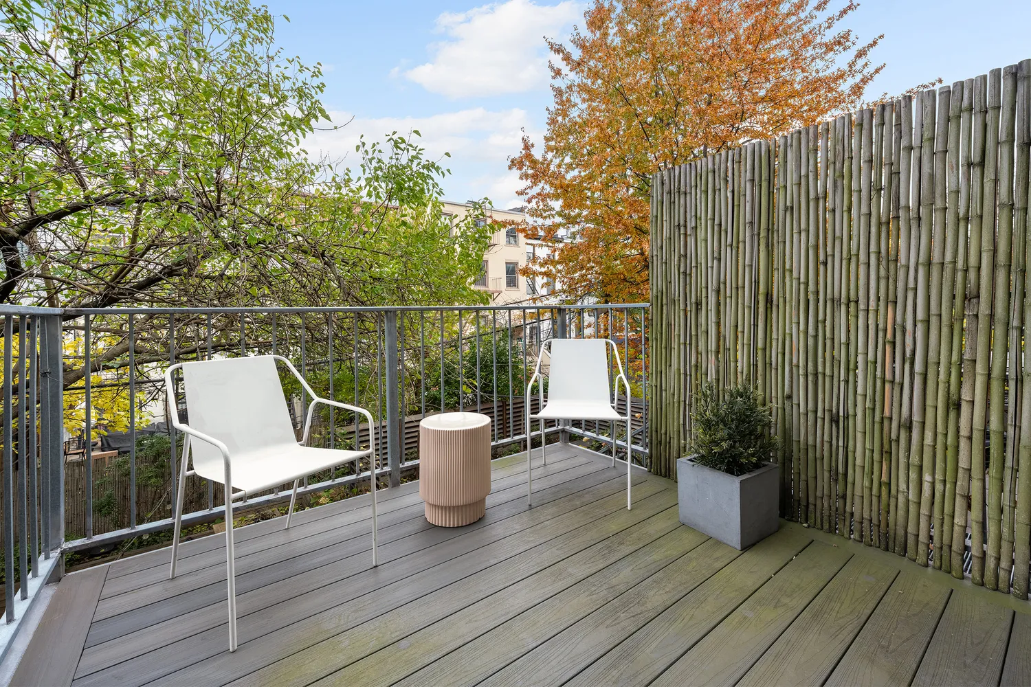a view of a balcony with chair and wooden floor