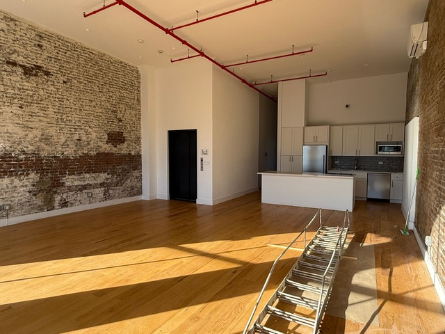 103 Broadway, Unit PH Brooklyn, NY 11249 - Photo 2 of 8 a view of a patio with a table and chairs