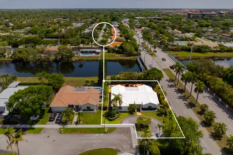 an aerial view of swimming pool playground and residential houses with outdoor space and seating