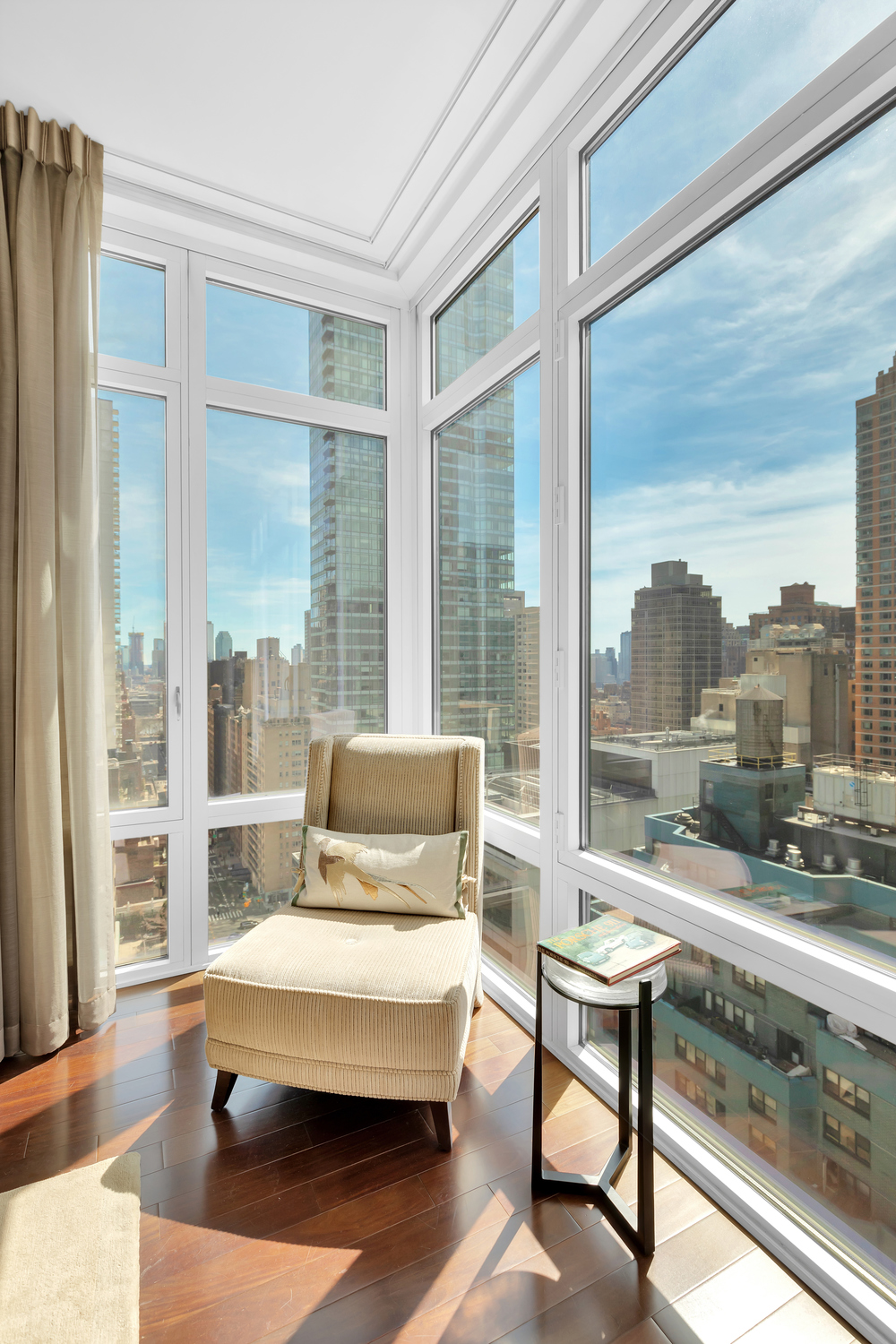 207 East 57th Street, Unit 25B Manhattan, NY 10022 - Photo 10 of 19 a living room with furniture city view and large windows