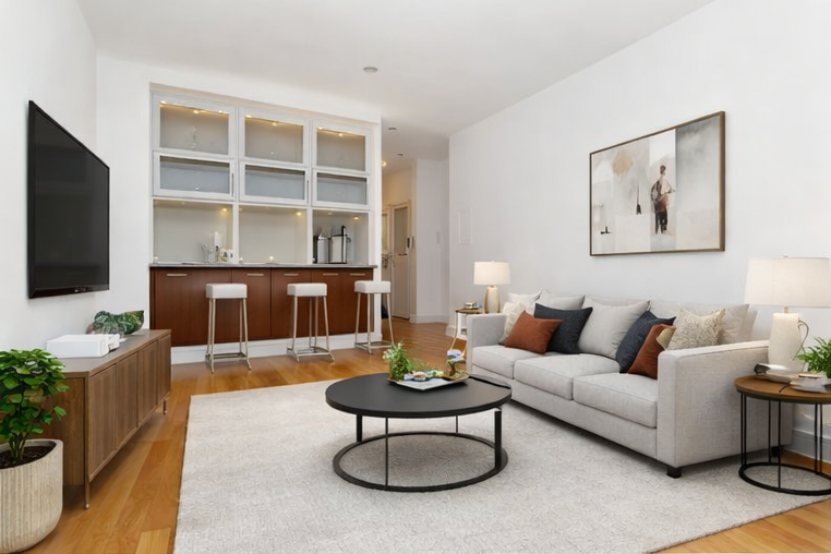 41-26 27th Street, Unit 6G Queens, NY 11101 - Photo 2 of 7 a living room with furniture a flat screen tv and a table