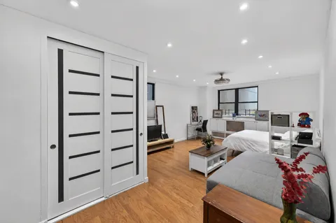 a living room with furniture and a wooden floor