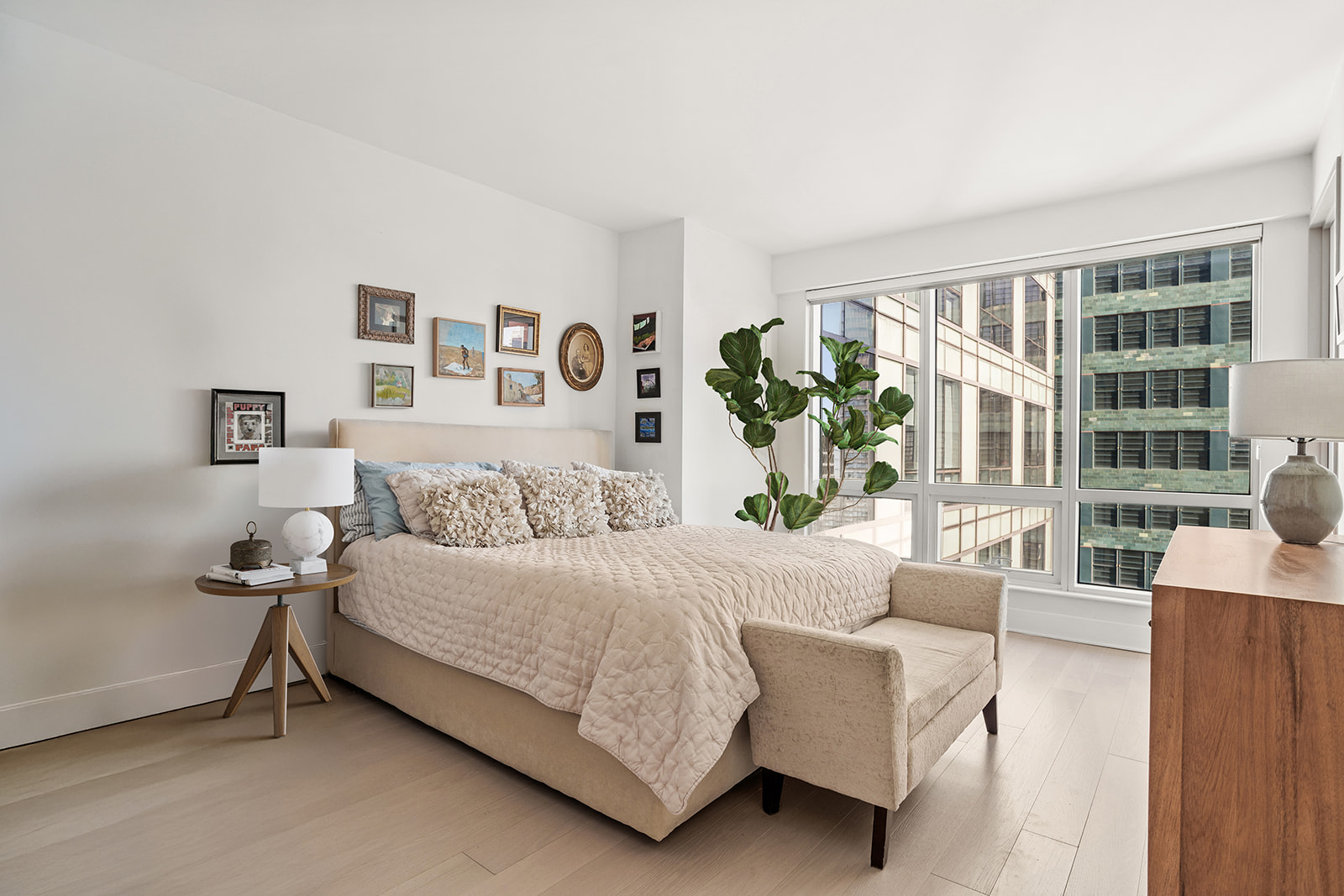 350 West 42nd Street, Unit 33G Manhattan, NY 10036 - Photo 8 of 20 a living room with a bed furniture and a large window