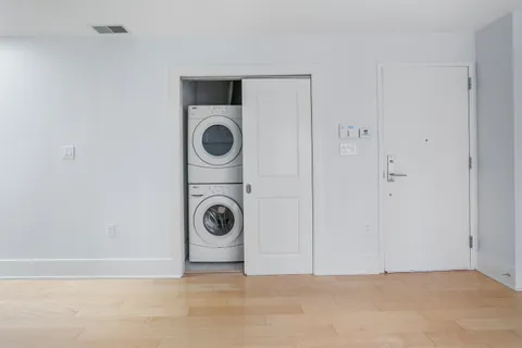 a view of a storage & utility room with dryer and washer