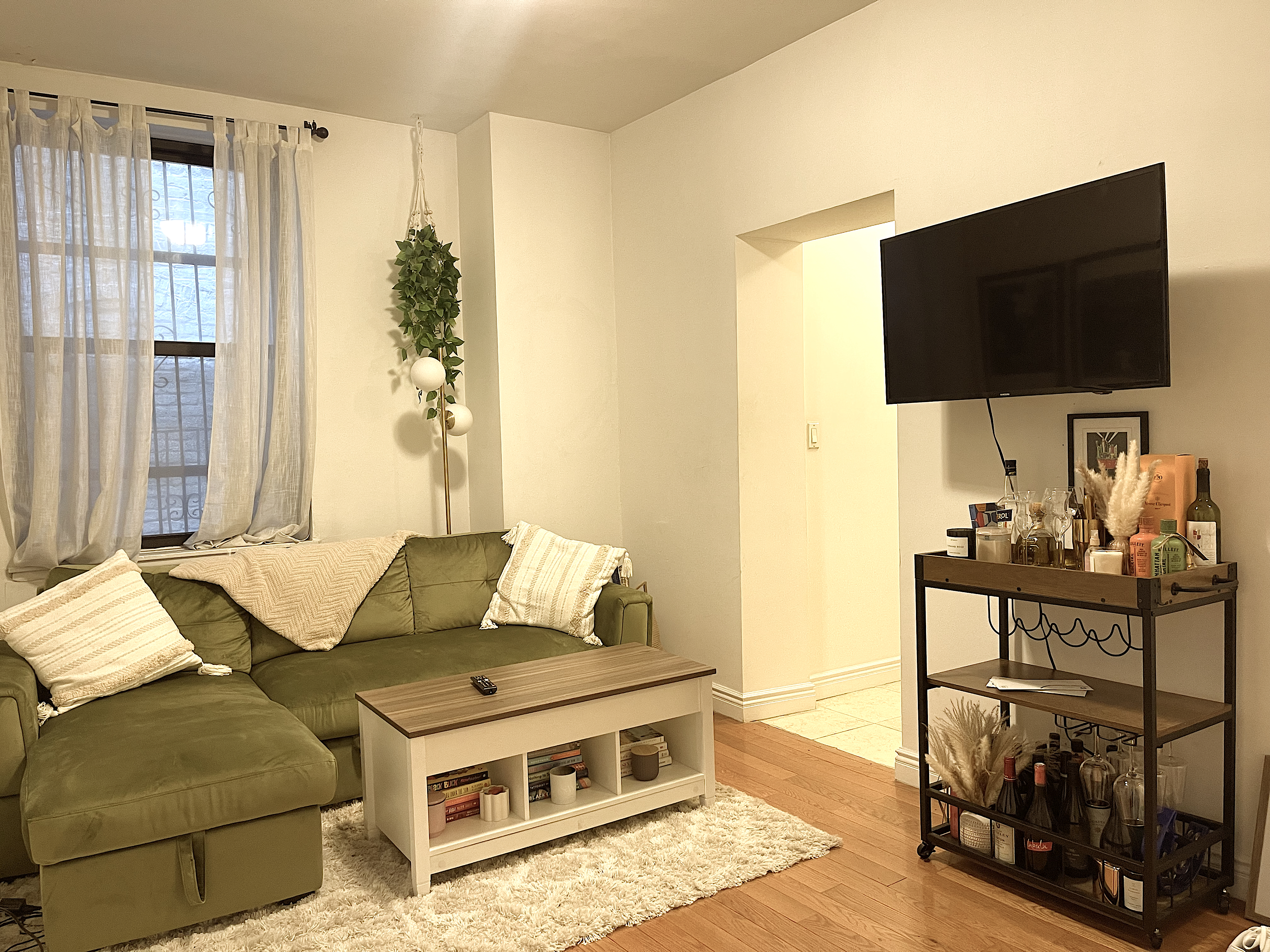 1716 2nd Avenue, Unit 4D Manhattan, NY 10128 - Photo 2 of 10 a living room with furniture and a flat screen tv
