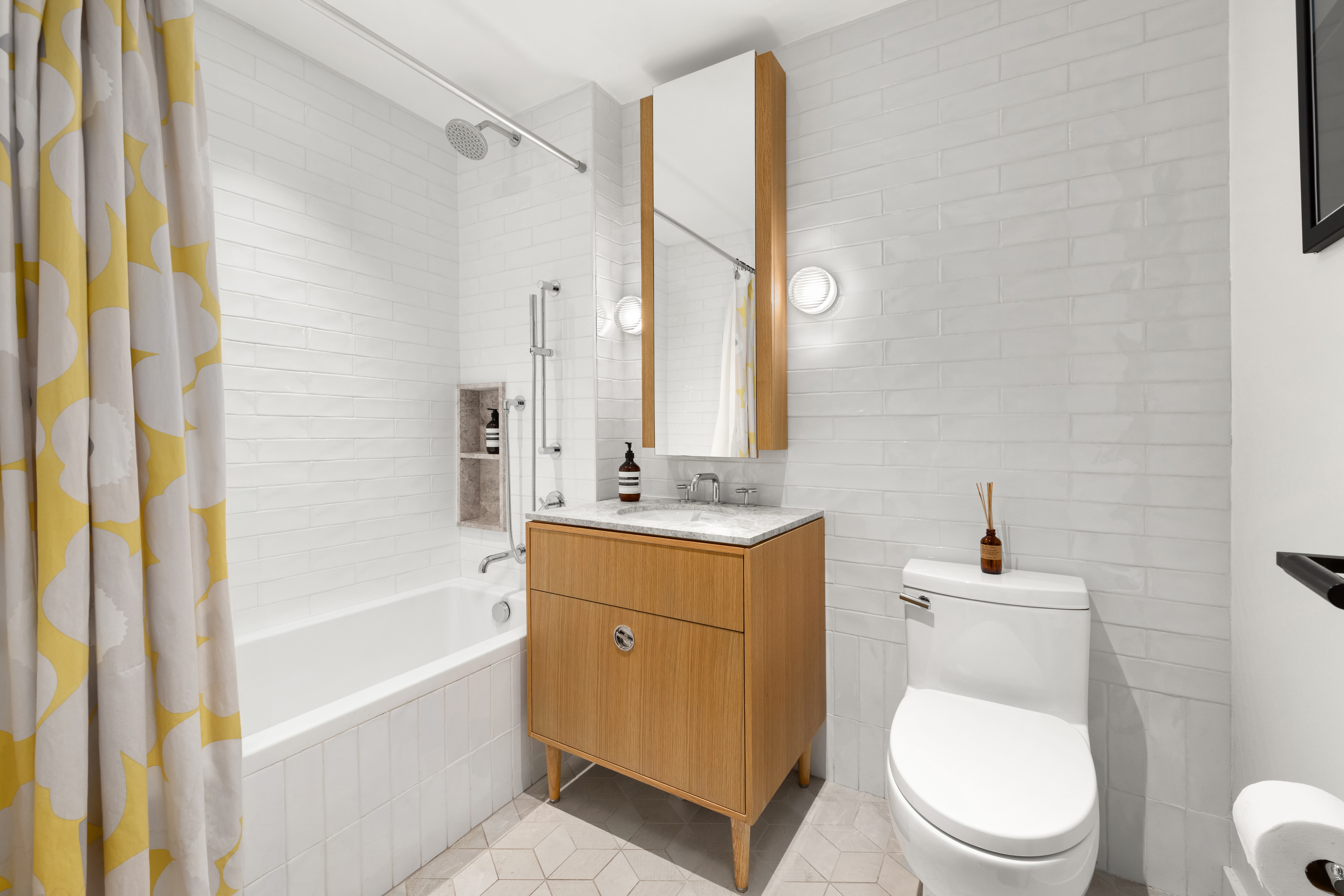 181 18th Street, Unit 214 Brooklyn, NY 11215 - Photo 7 of 16 a bathroom with a sink a toilet and shower