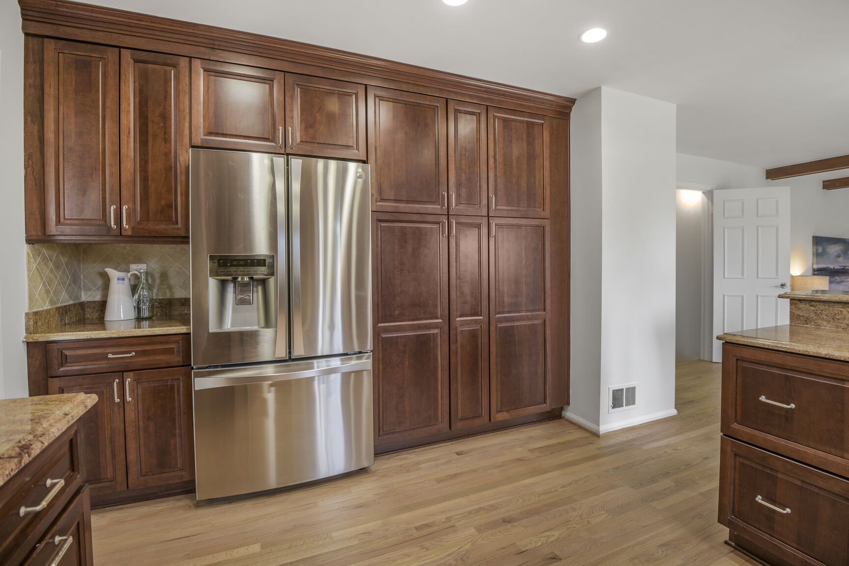 4008 Evangeline Terrace Olney, MD 20832 - Photo 24 of 54 a kitchen with granite countertop stainless steel appliances wooden floor and cabinets