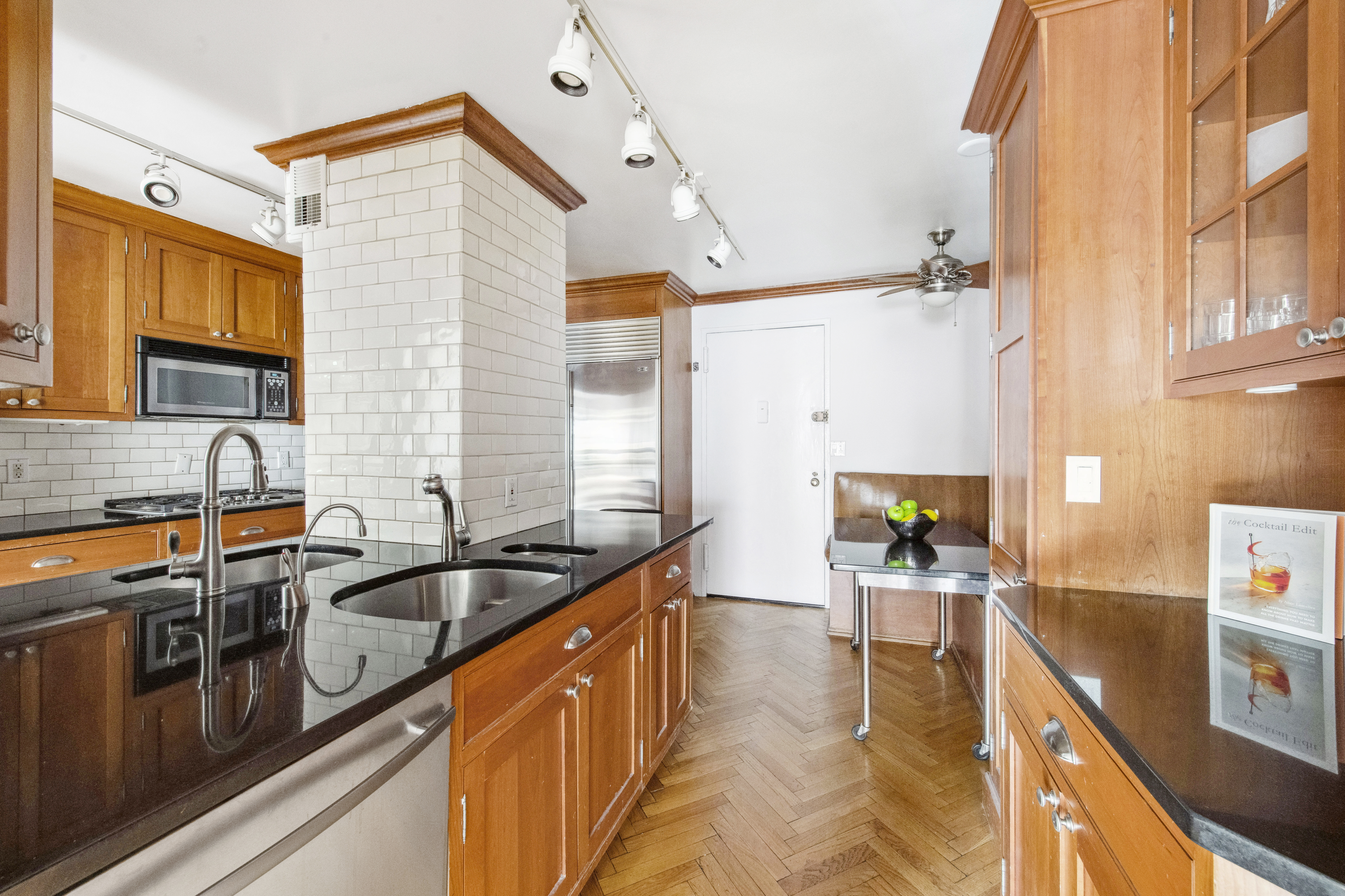 155 West 68th Street, Unit 404 Manhattan, NY 10023 - Photo 6 of 21 a kitchen that has a sink and a stove