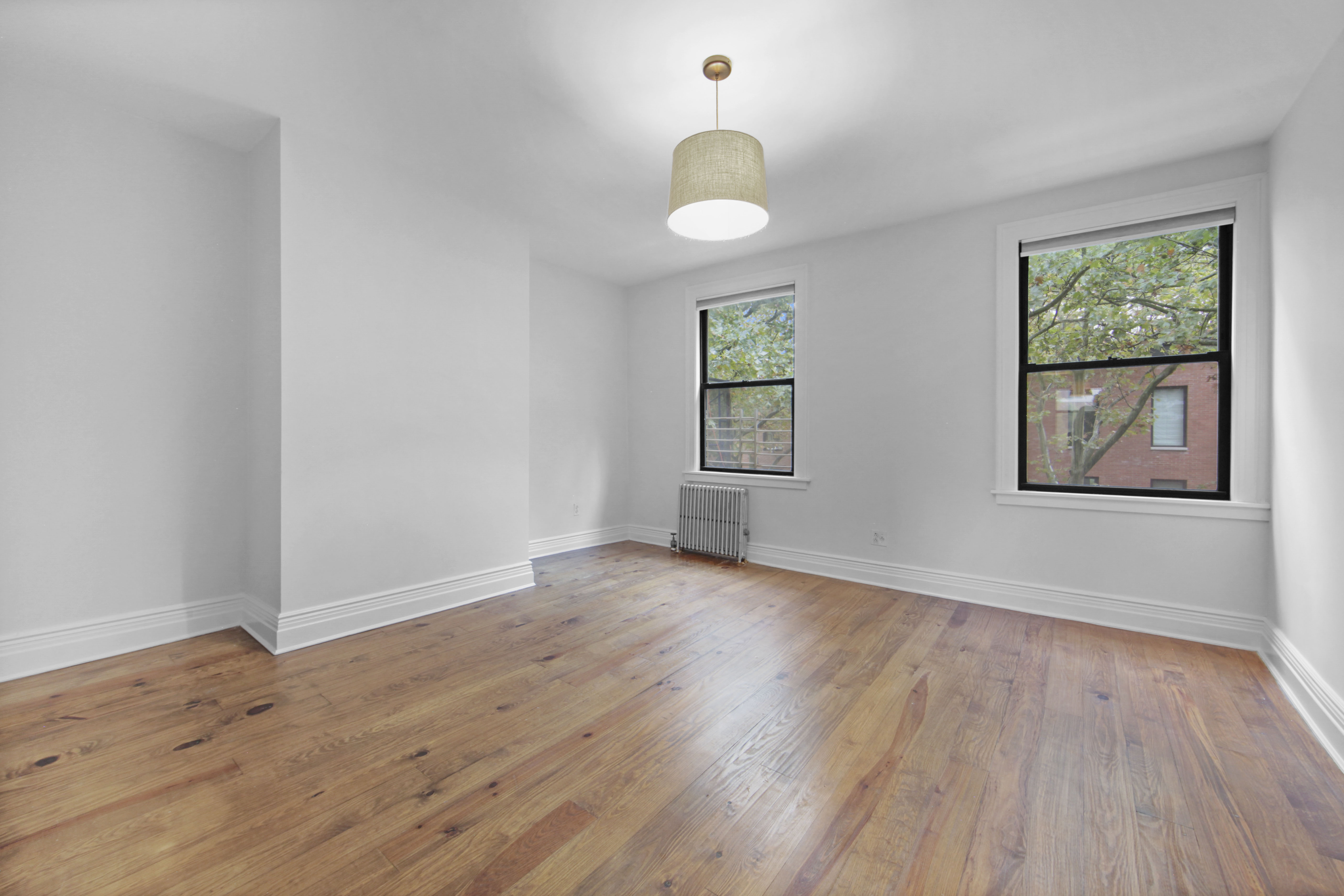 43 Douglass Street, Unit 3 Brooklyn, NY 11231 - Photo 5 of 12 a view of an empty room with wooden floor and a window