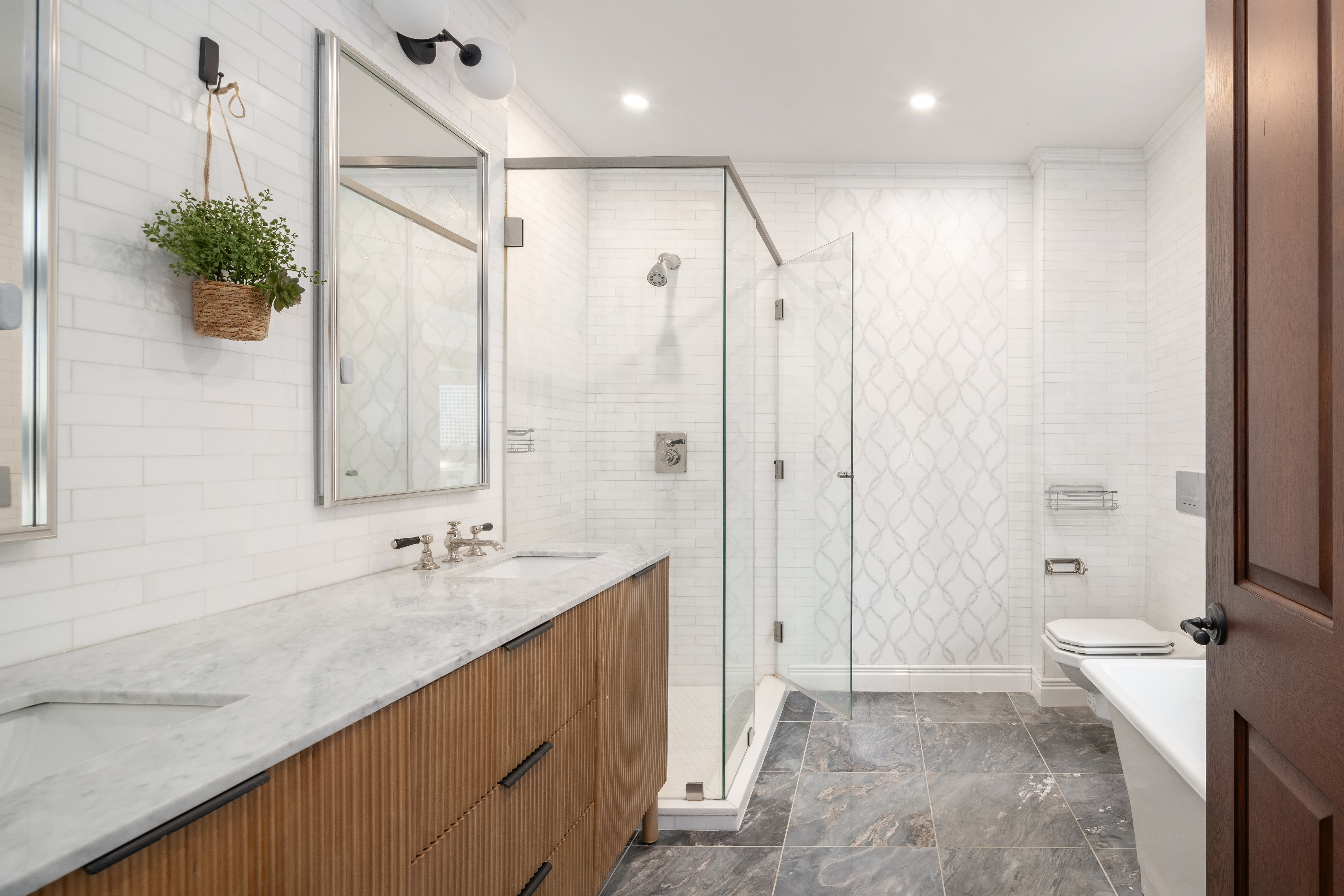 199 Mott Street, Unit 2 Manhattan, NY 10012 - Photo 11 of 14 a bathroom with a double vanity sink toilet and shower