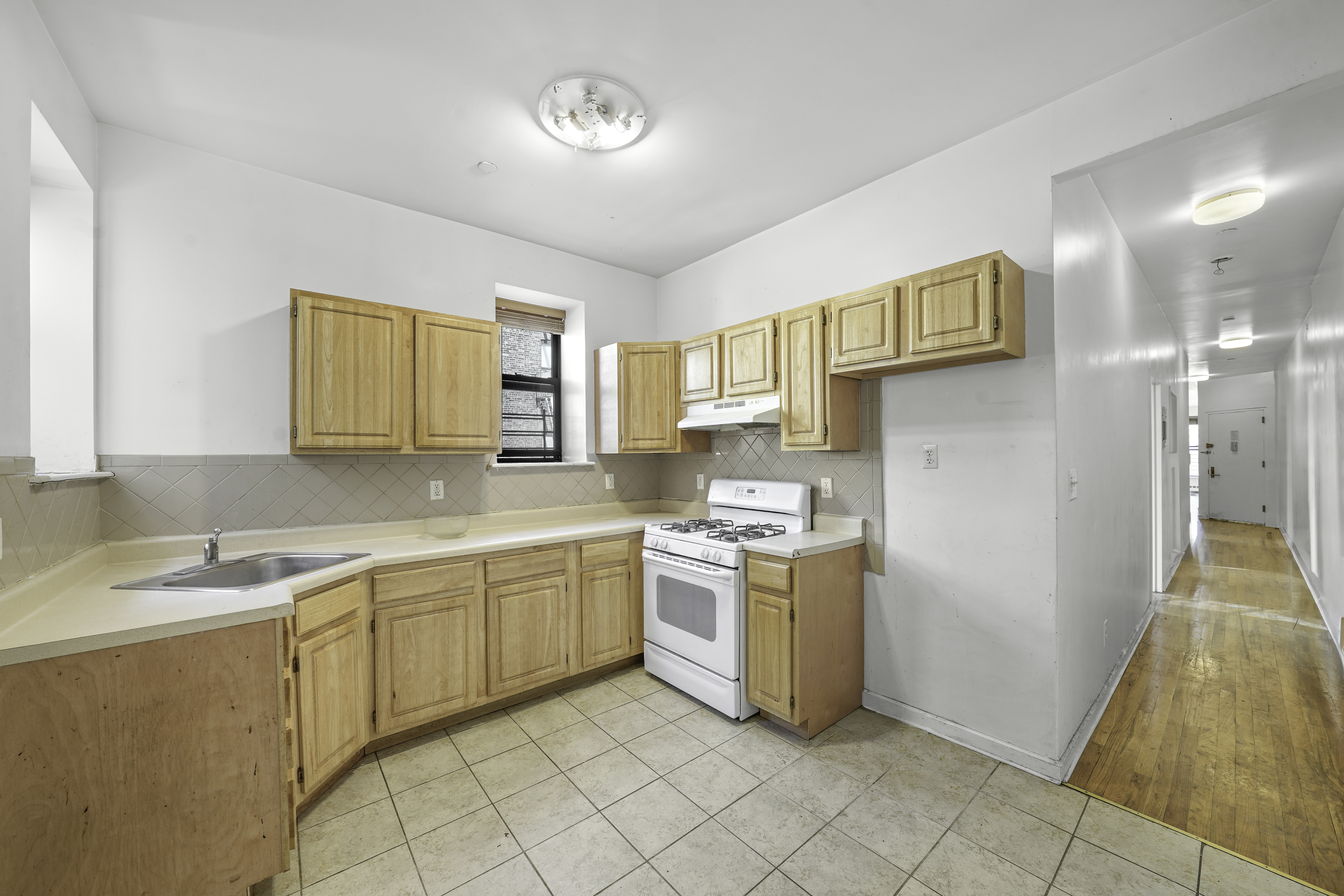 163 Lenox Avenue, Unit 5A Manhattan, NY 10026 - Photo 12 of 16 a kitchen with a sink and cabinets
