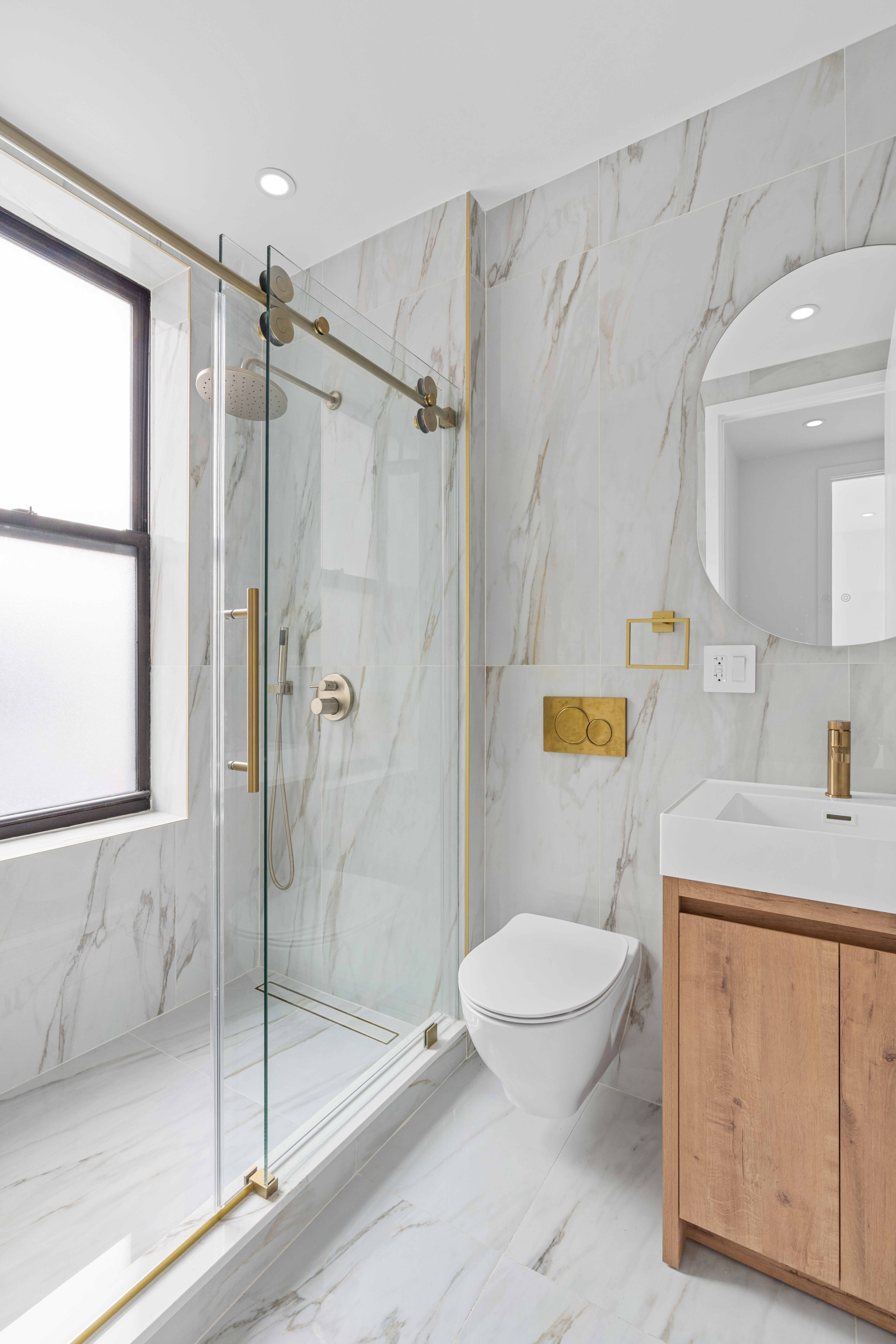 216 Flatbush Avenue, Unit 2 Brooklyn, NY 11217 - Photo 7 of 8 a bathroom with a granite countertop sink a toilet and shower