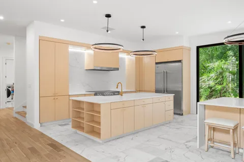 a kitchen with a stove a refrigerator and a sink