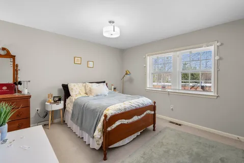 a bed room with a bed and a window