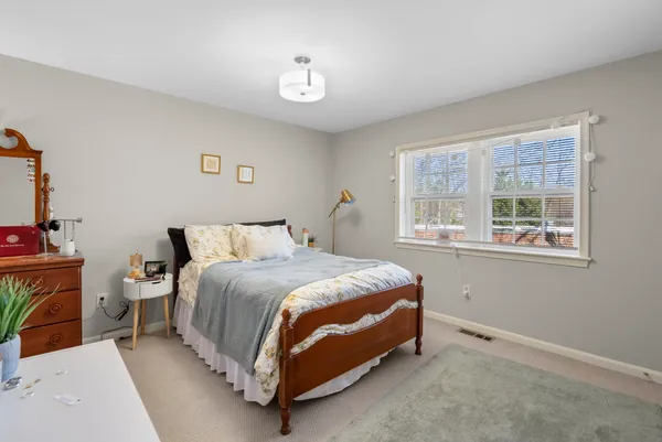 a bed room with a bed and a window