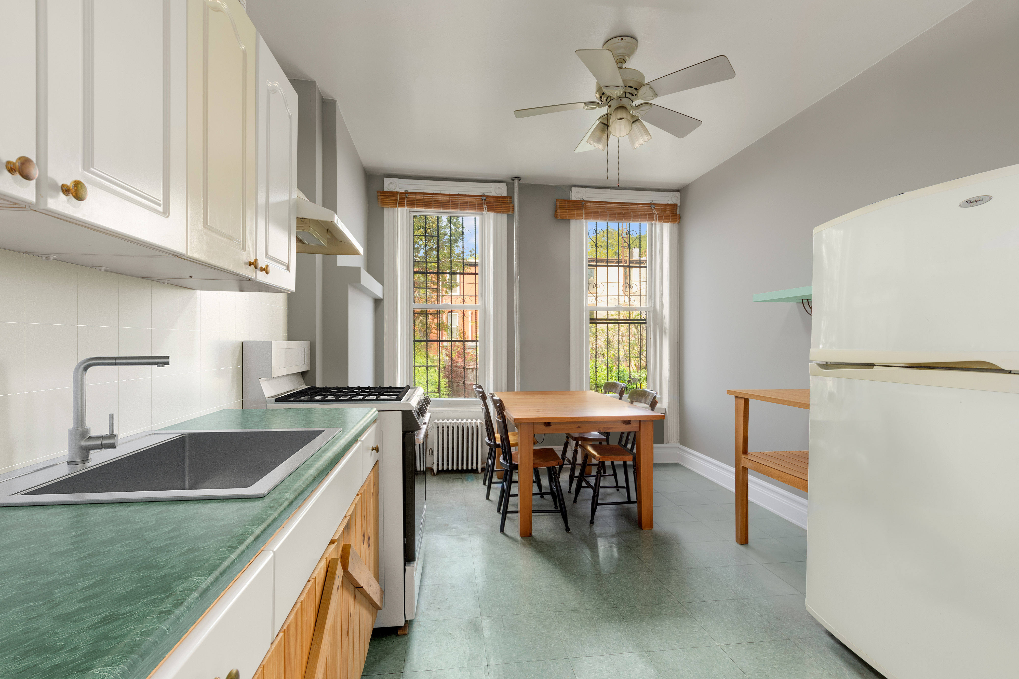 449 11th Street Brooklyn, NY 11215 - Photo 9 of 17 a kitchen with a table chairs sink and cabinets