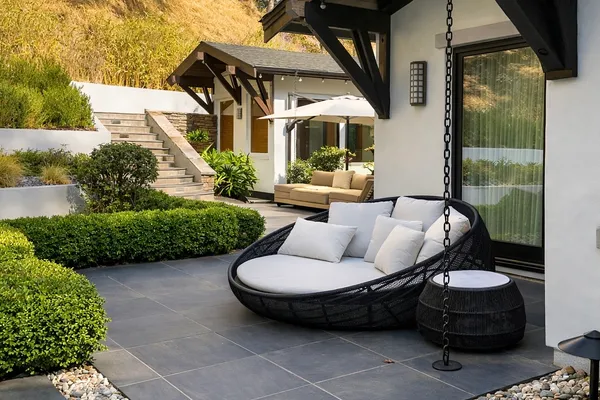 a roof deck with couches and wooden fence