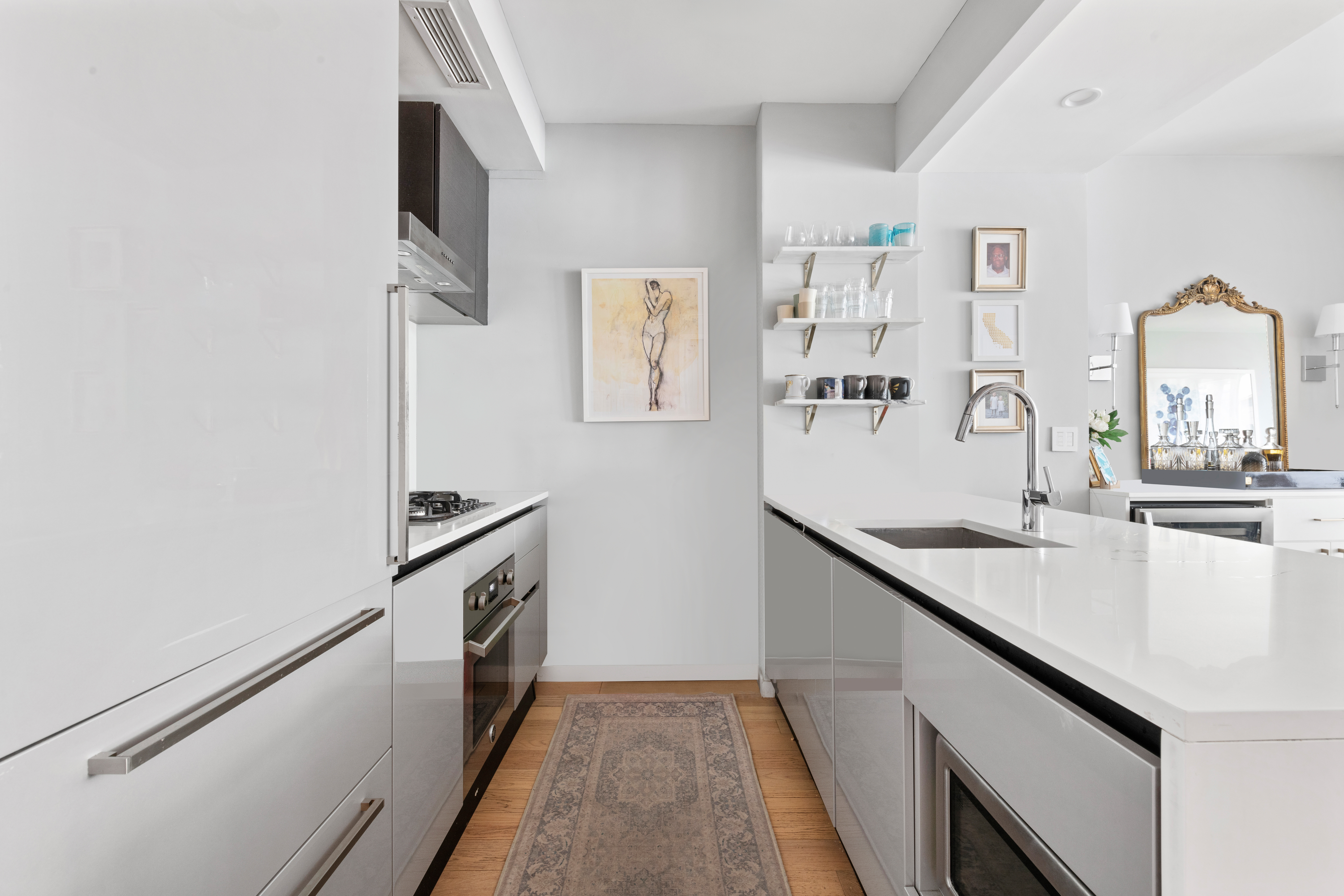 540 West 49th Street, Unit 401S Manhattan, NY 10019 - Photo 4 of 14 a kitchen with a sink and a refrigerator