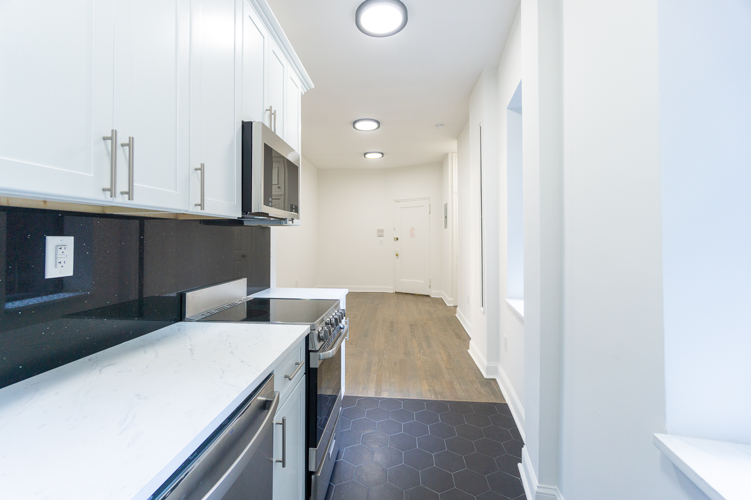 51 East 2nd Street, Unit 2 Manhattan, NY 10003 - Photo 7 of 18 a kitchen that has a microwave and a stove
