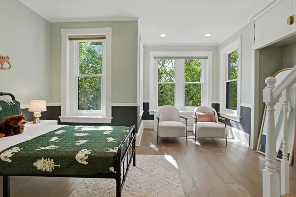 a living room with fireplace furniture and a large window
