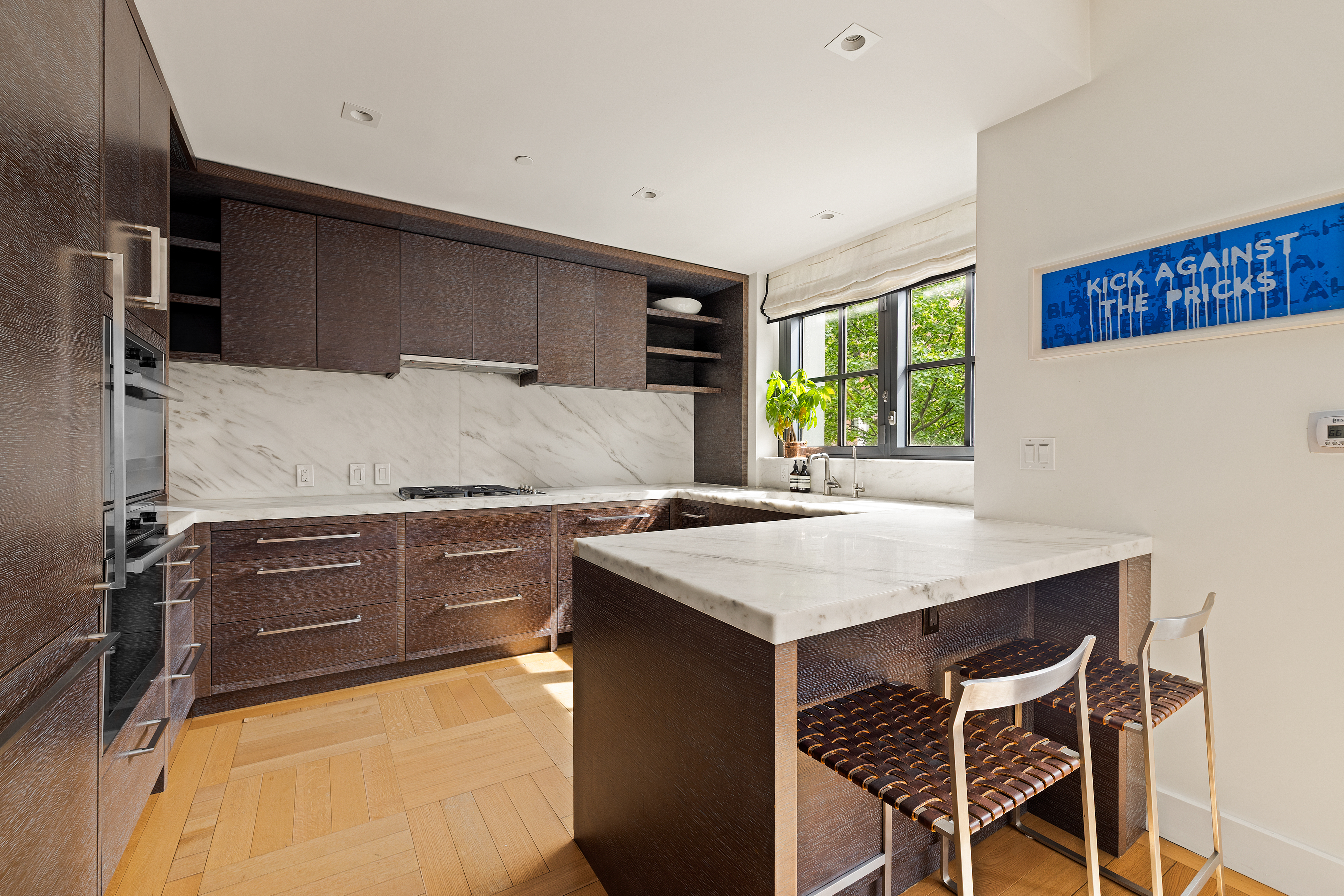 500 West 21st Street, Unit 2G Manhattan, NY 10011 - Photo 5 of 21 a kitchen with a stove a sink and a refrigerator