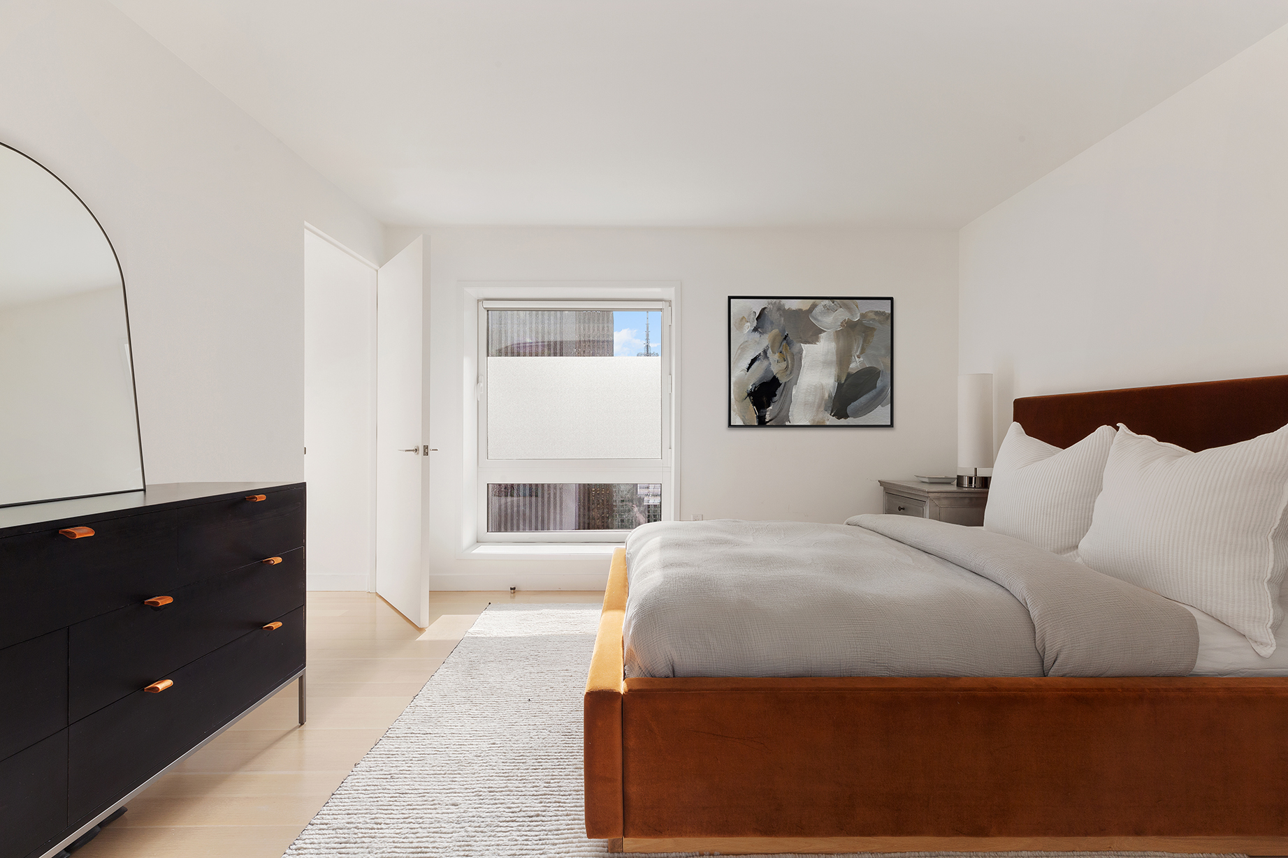 135 West 52nd Street, Unit PH3 Manhattan, NY 10019 - Photo 13 of 17 a bedroom with a bed and a painting on the wall