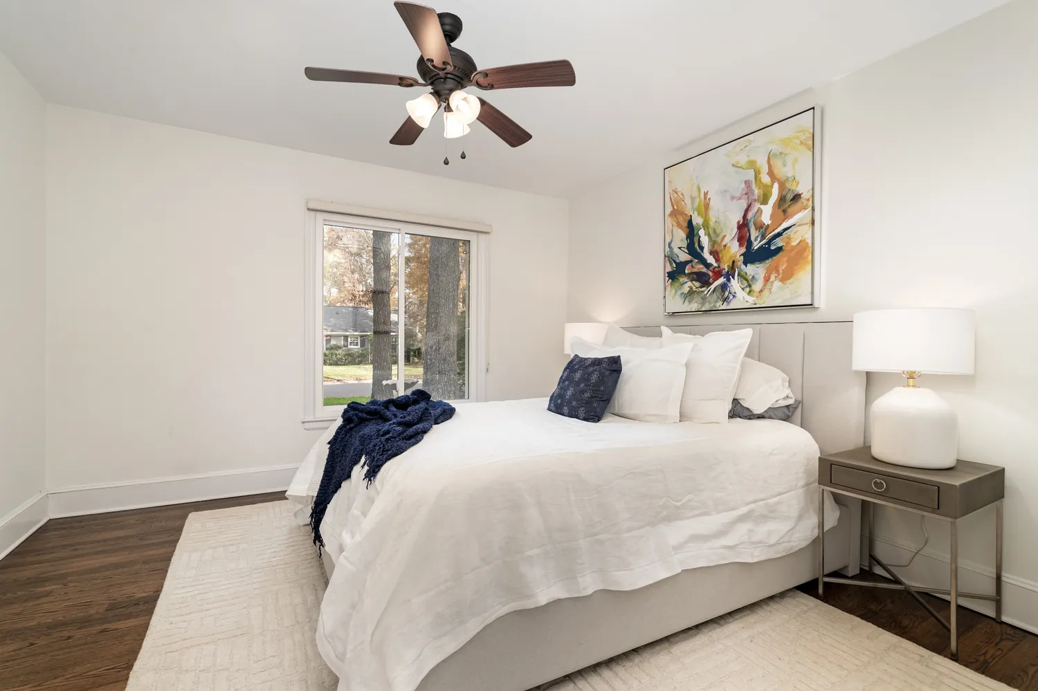 a bedroom with a large bed and a window