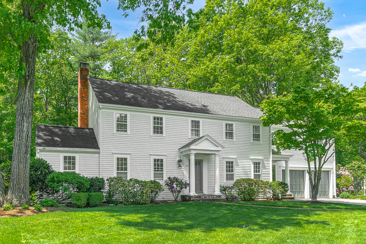 a front view of a house with a garden and plants