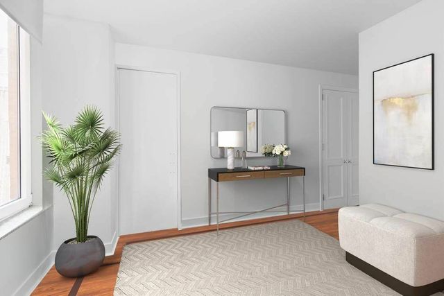 30 East 85th Street, Unit 8B Manhattan, NY 10028 - Photo 2 of 12 a living room with furniture and a potted plant