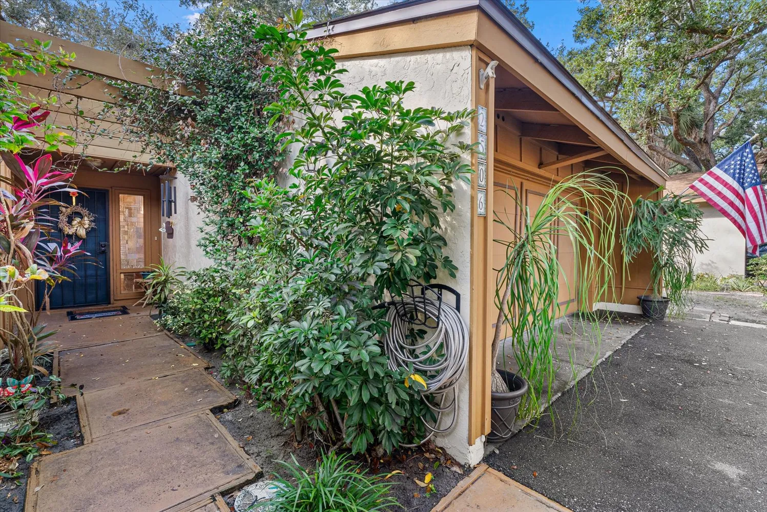 a view of backyard with outdoor seating a patio and plants